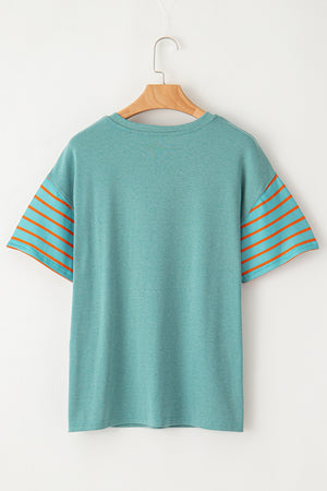Turquoise raglan tee with orange striped sleeves and side slits