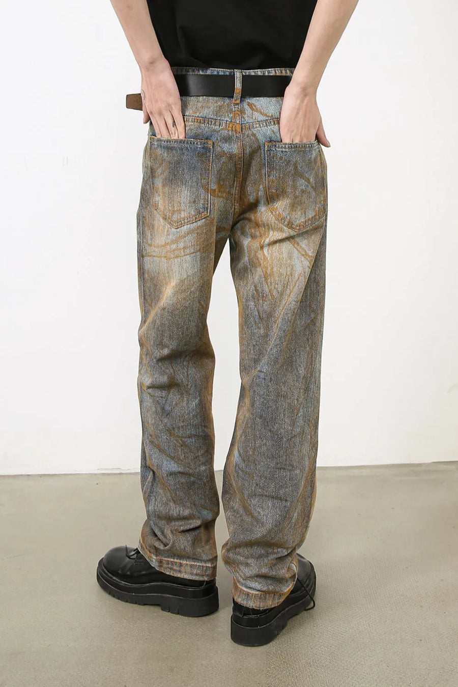 Relaxed fit acid wash denim jeans in medium blue with a distressed look.