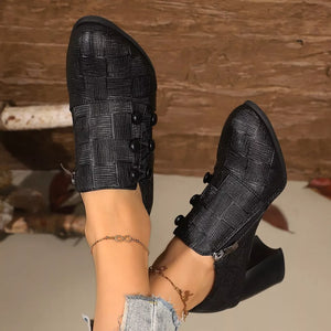 Black woven button-detail high heels with pointed toe and side zipper.