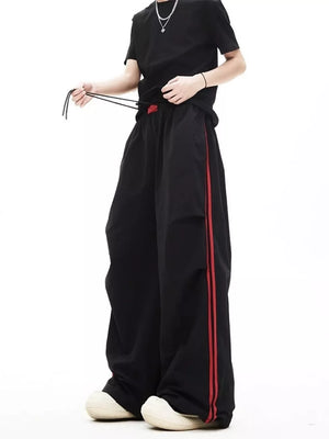 red wide-leg pants featuring drawstring waist and striped