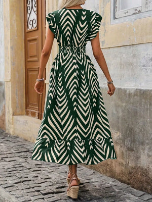 Dark green geometric ruffled midi dress with elastic waist and cap sleeves.