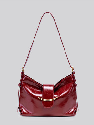 shoulder bag in burgundy featuring patent finish and soft fit