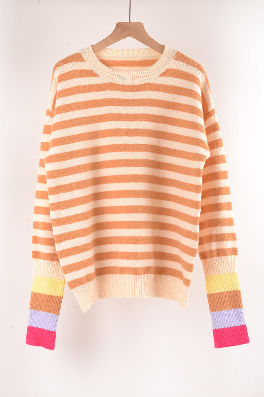 Acrylic sweater with orange and cream horizontal stripes and colorful striped cuffs.