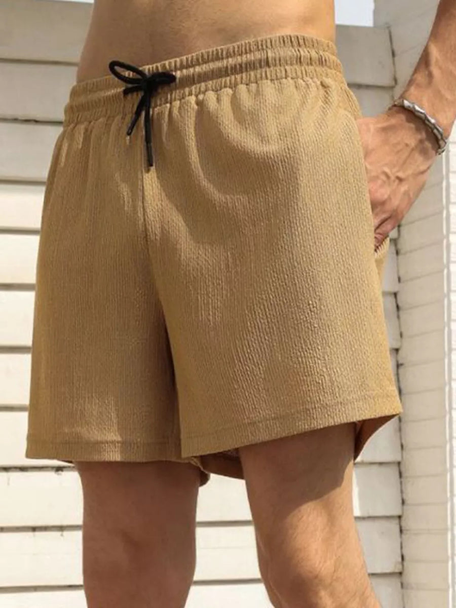Men's khaki chino shorts with drawstring waist and textured fabric.