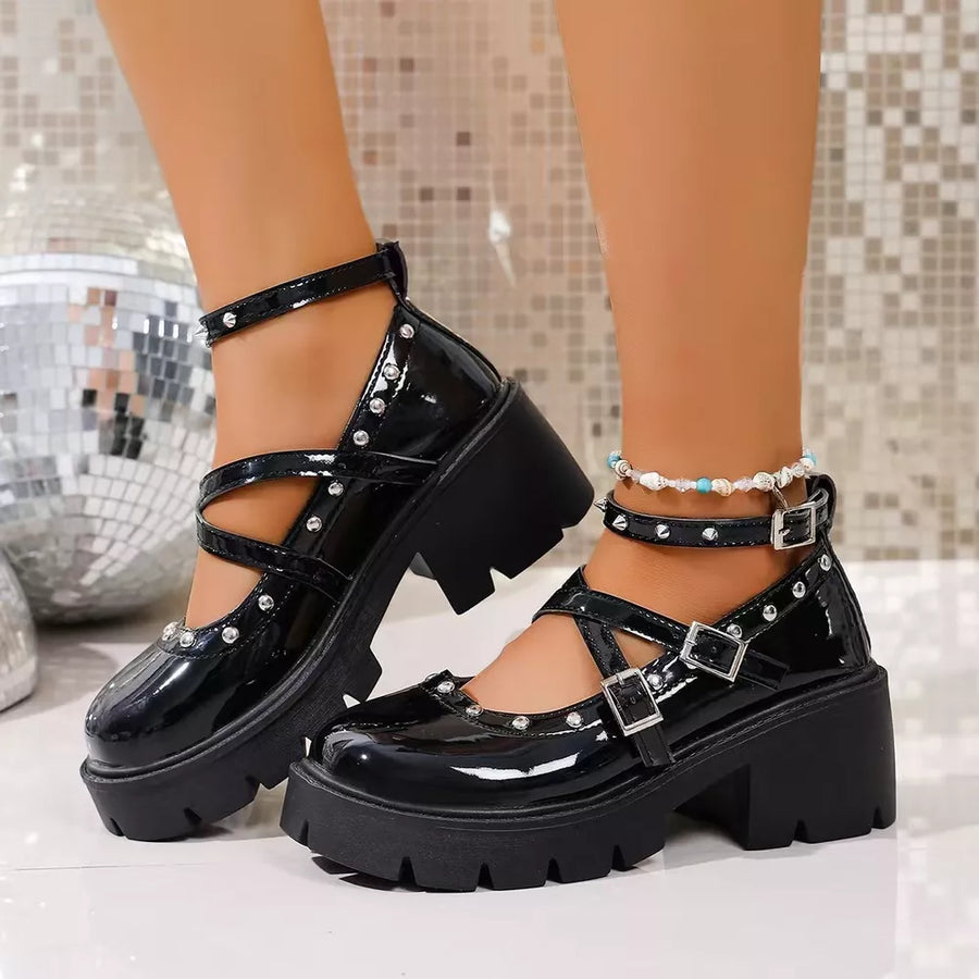 Black patent platform Mary Jane sneakers with studded straps and buckles.