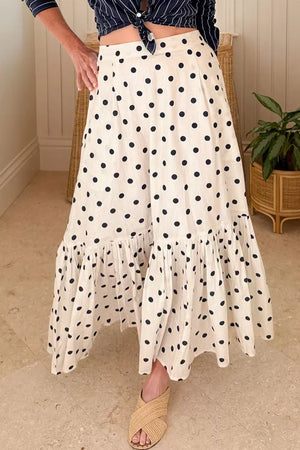 Chic polka dot maxi skirt with ruffled hem in beige.