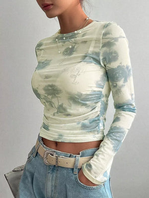 Sheer long sleeve t-shirt with floral print and ruched sides.