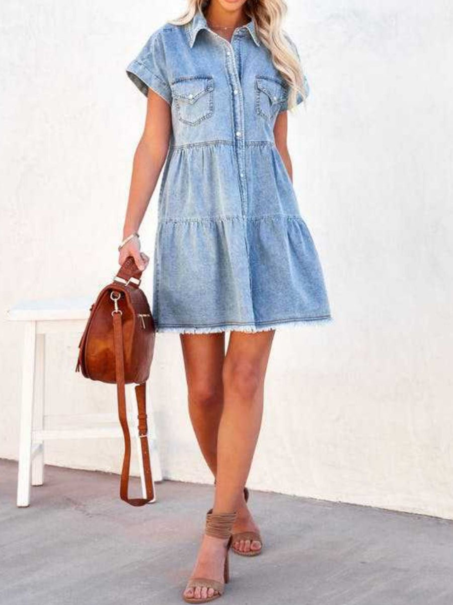 Light blue tiered denim shirt dress with frayed hem, short sleeves, and button front.