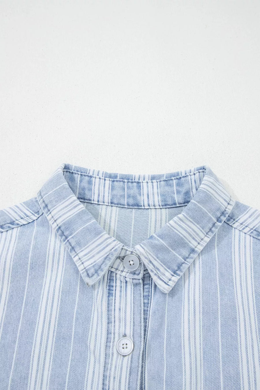 Denim shacket with vertical white stripes, button-down collar, and button closure.