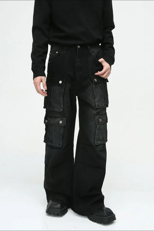 Dark denim wide-leg cargo pants with multiple utility pockets and silver button closures.