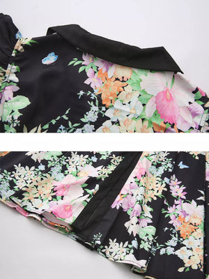 Black floral midi dress with ruffle sleeves and collar detail.
