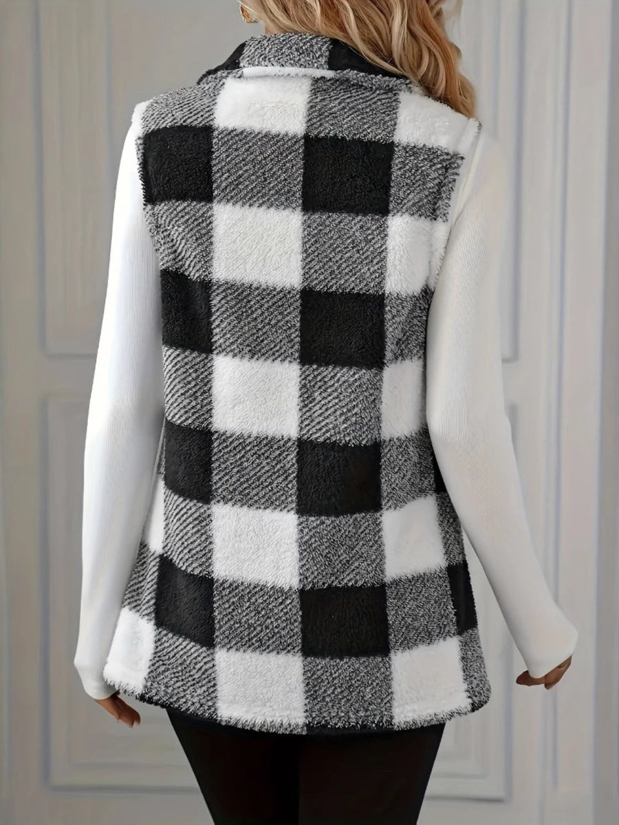 Textured black and white buffalo check vest jacket with collar and buttoned front, worn over a white long-sleeve shirt.