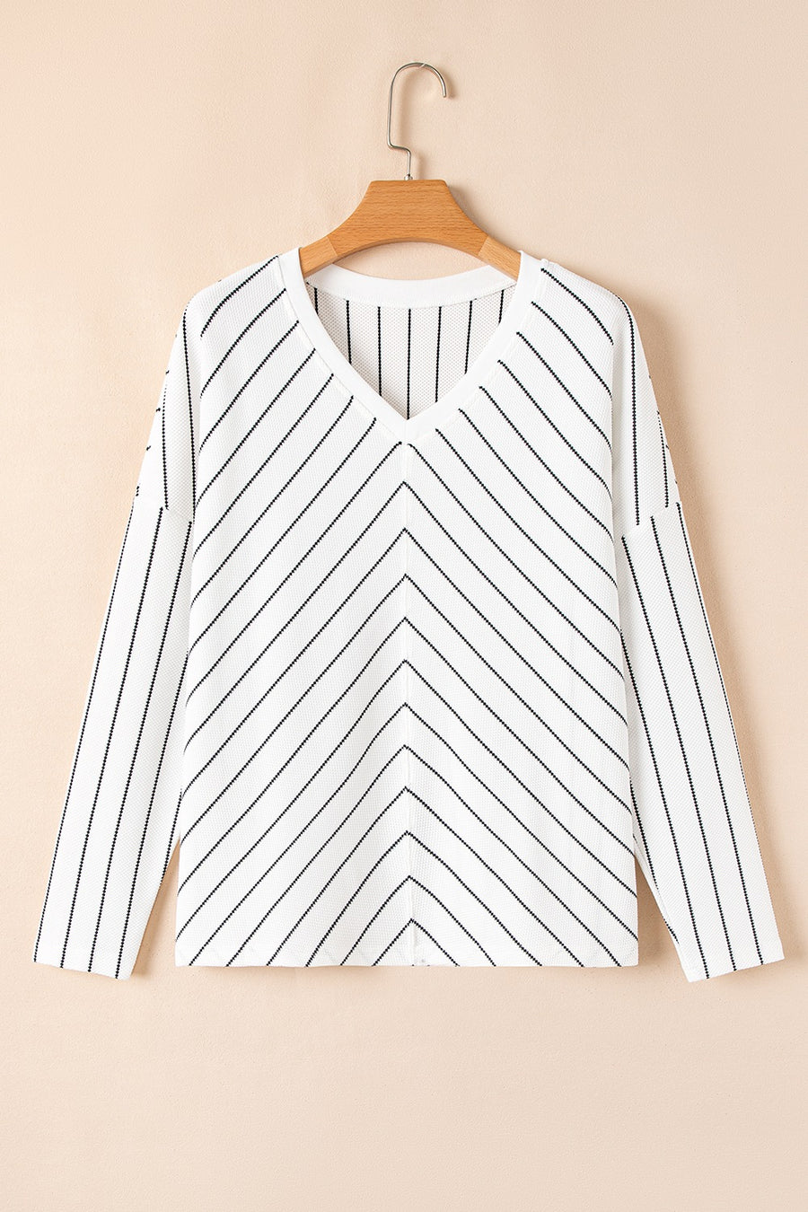 White chevron stripe v-neck relaxed fit blouse with long sleeves.