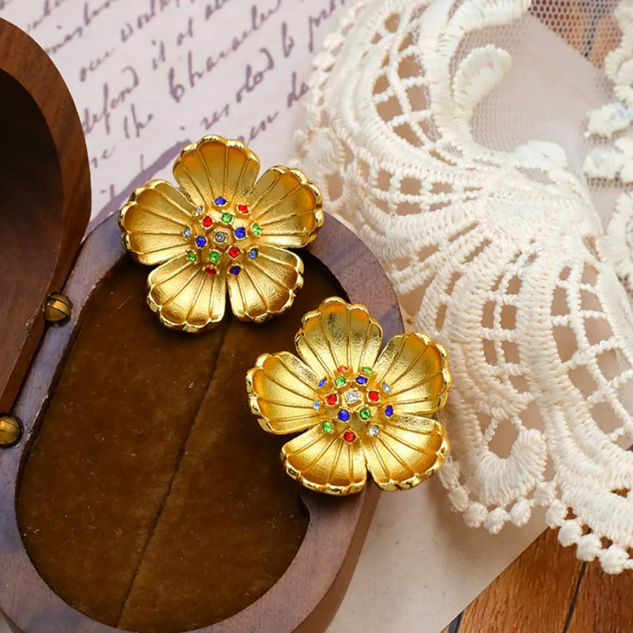 Gold earrings featuring flower shape and floral