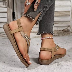 Brown rhinestone-embellished toe post sandals with elastic ankle straps.