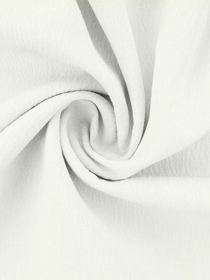 White polyester pajama fabric with soft ruffles and a textured weave.