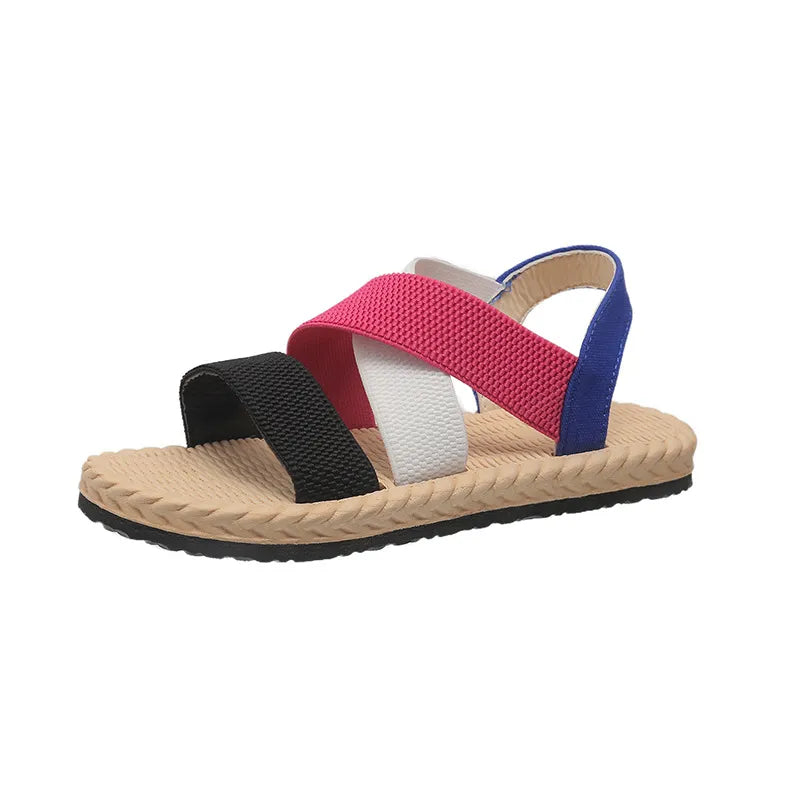 Crisscross elastic summer sandals with black, white, hot pink, and blue straps on a tan sole.