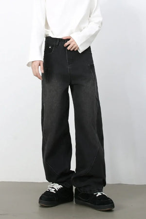 Black denim baggy trousers with a relaxed fit and visible stitching detail.