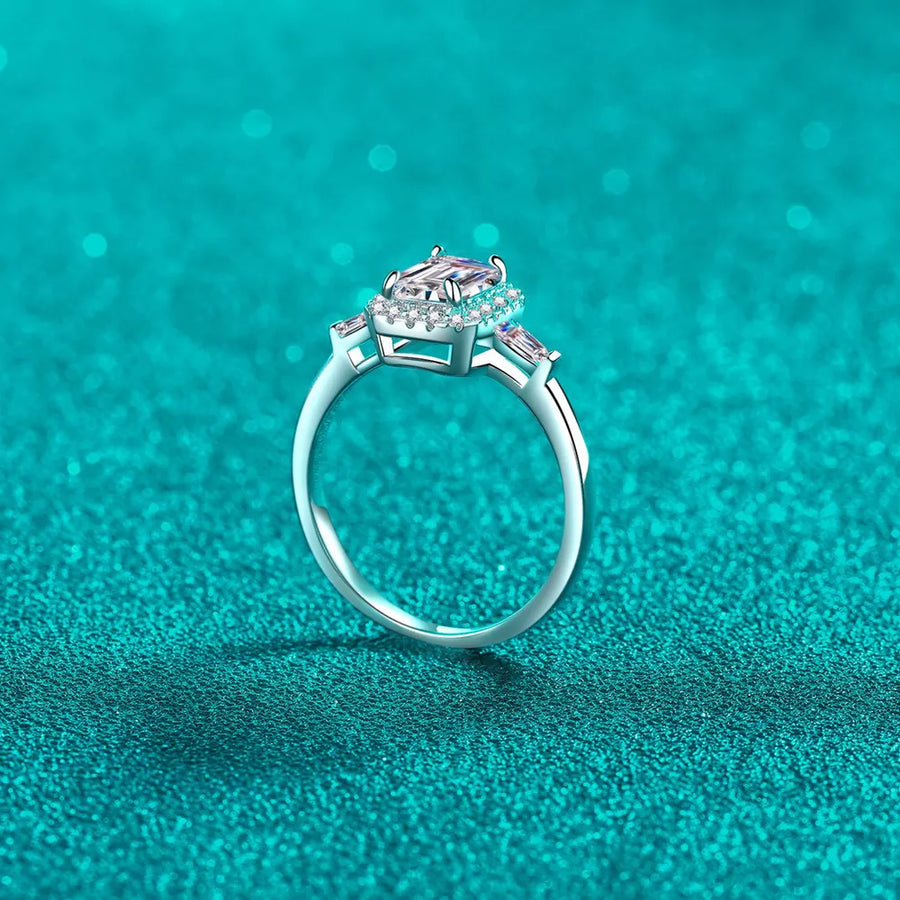 Sterling silver ring with emerald cut moissanite and halo, available in royal blue and white