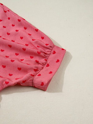 Red gingham button-down shirt with a small red heart pattern and cuffed sleeves.