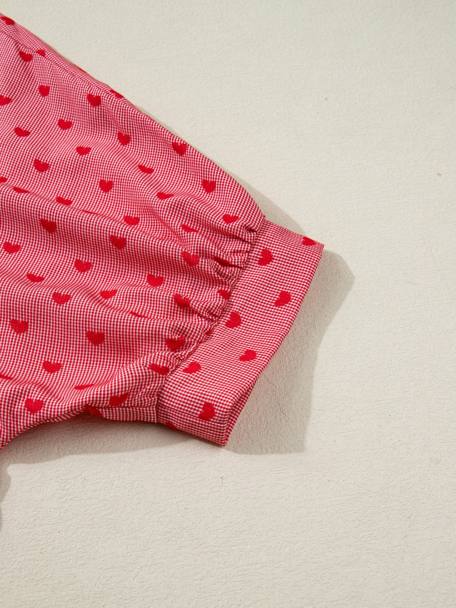Red gingham button-down shirt with a small red heart pattern and cuffed sleeves.