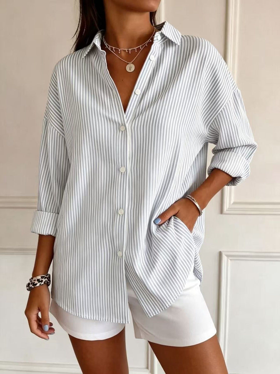 light blue button-down shirt featuring buttoned and striped