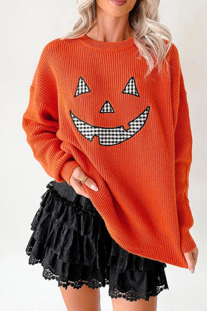 orange pullover sweater with graphic print and round neck