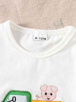 White cotton baby tee with embroidered tractor and pig detail, crew neck.