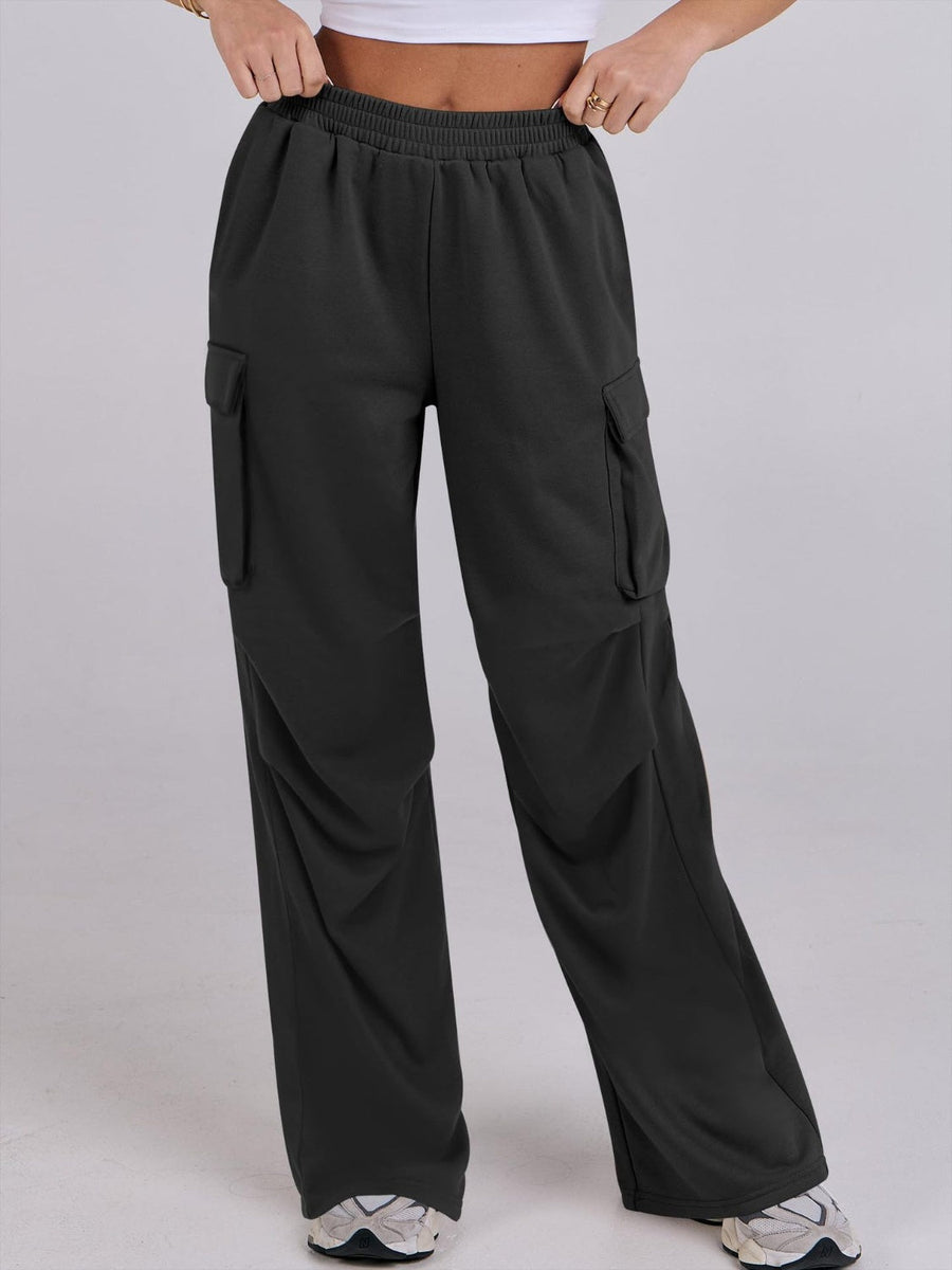 Black sweatpants with cargo pockets and a wide leg, featuring a comfortable elastic waistband.