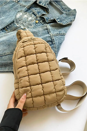 Padded sling bag in camel with quilted pattern and top handle