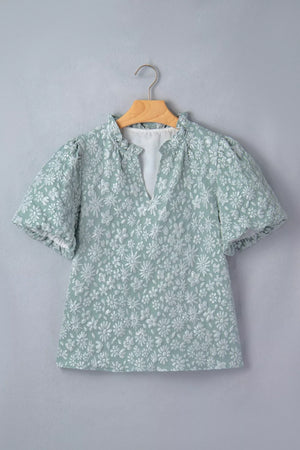 Embroidered puff sleeve floral shirt in light green polyester with ruffled neckline and V-neck.