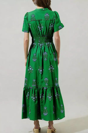 Green cotton maxi dress with smocked waist, puff sleeves, tiered hem, and blue floral print.