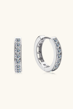 Silver moissanite channel-set hoop earrings with sparkling stones.