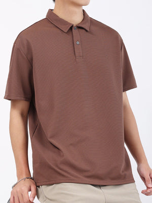 Brown textured performance polo shirt for men with short sleeves and a two-button placket.