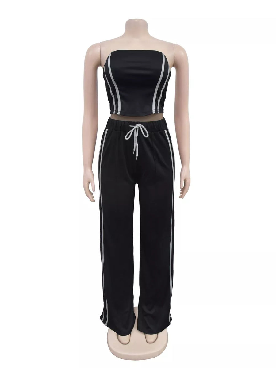 Black tube top and wide-leg pant set with white stripe detail and drawstring waist.