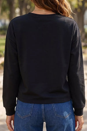 orange sweatshirt featuring rhinestone embellishment and checkered