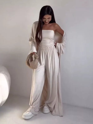 Tan three-piece maternity set with cardigan, strapless top, and wide-leg pants.