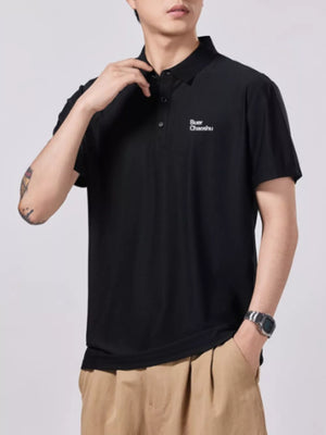 Black short-sleeve cotton polo with button detail and embroidered text.