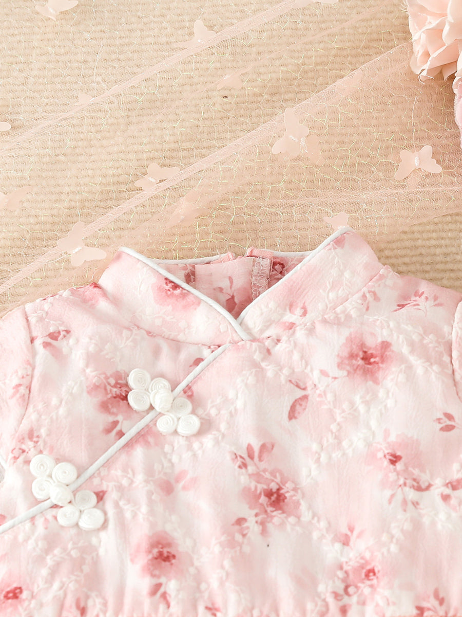 Pink floral cap sleeve baby dress with white frog buttons and butterfly trim.