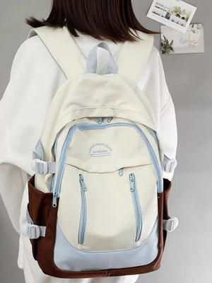 Chic color block nylon backpack in cream, brown, and light blue with multiple zippered pockets.