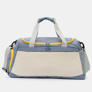 Colorblock gym duffel bag in dusty blue and beige with yellow accents and mesh side pocket.
