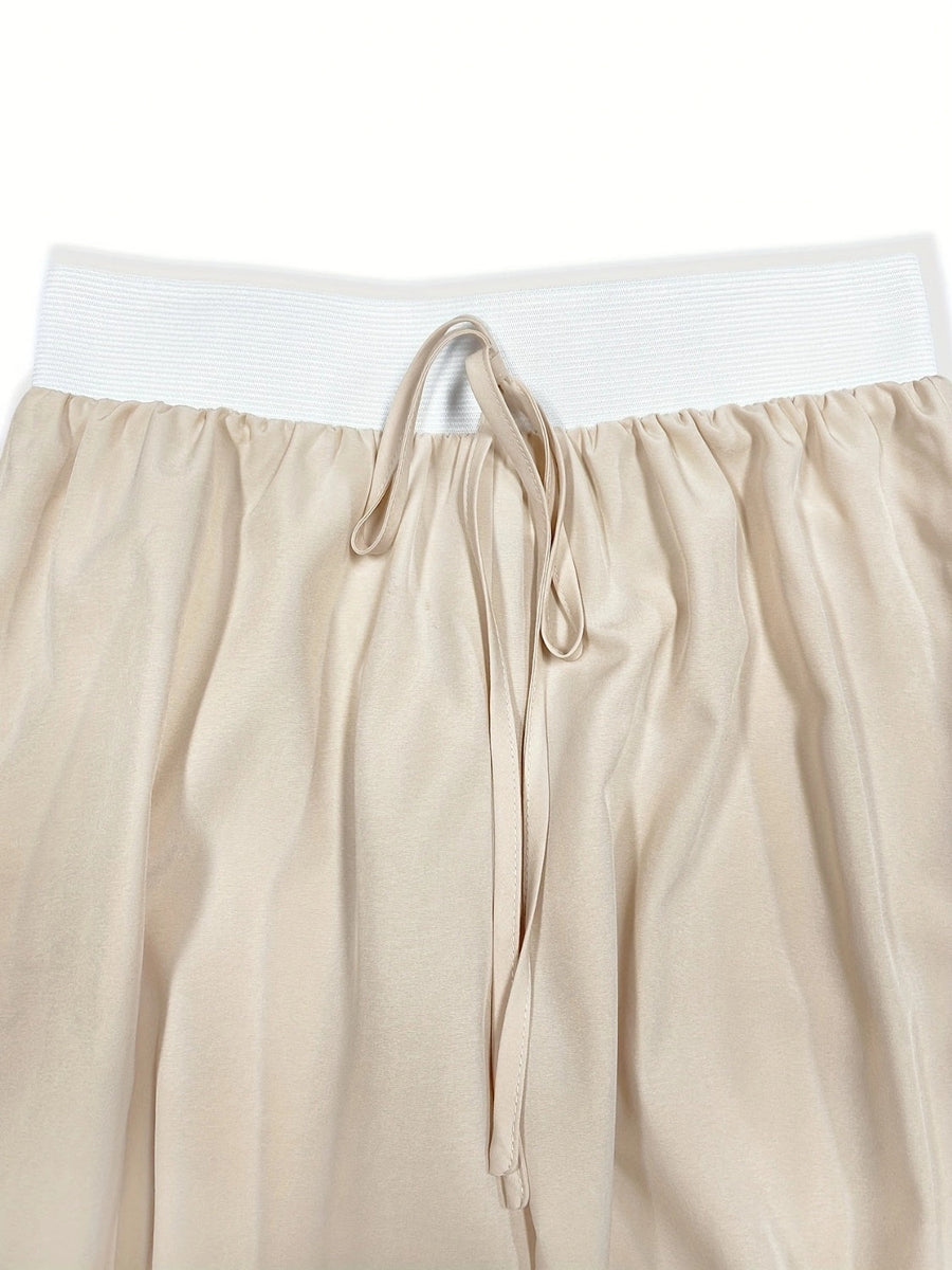 Beige wide-leg pants with elastic waistband and drawstring detail