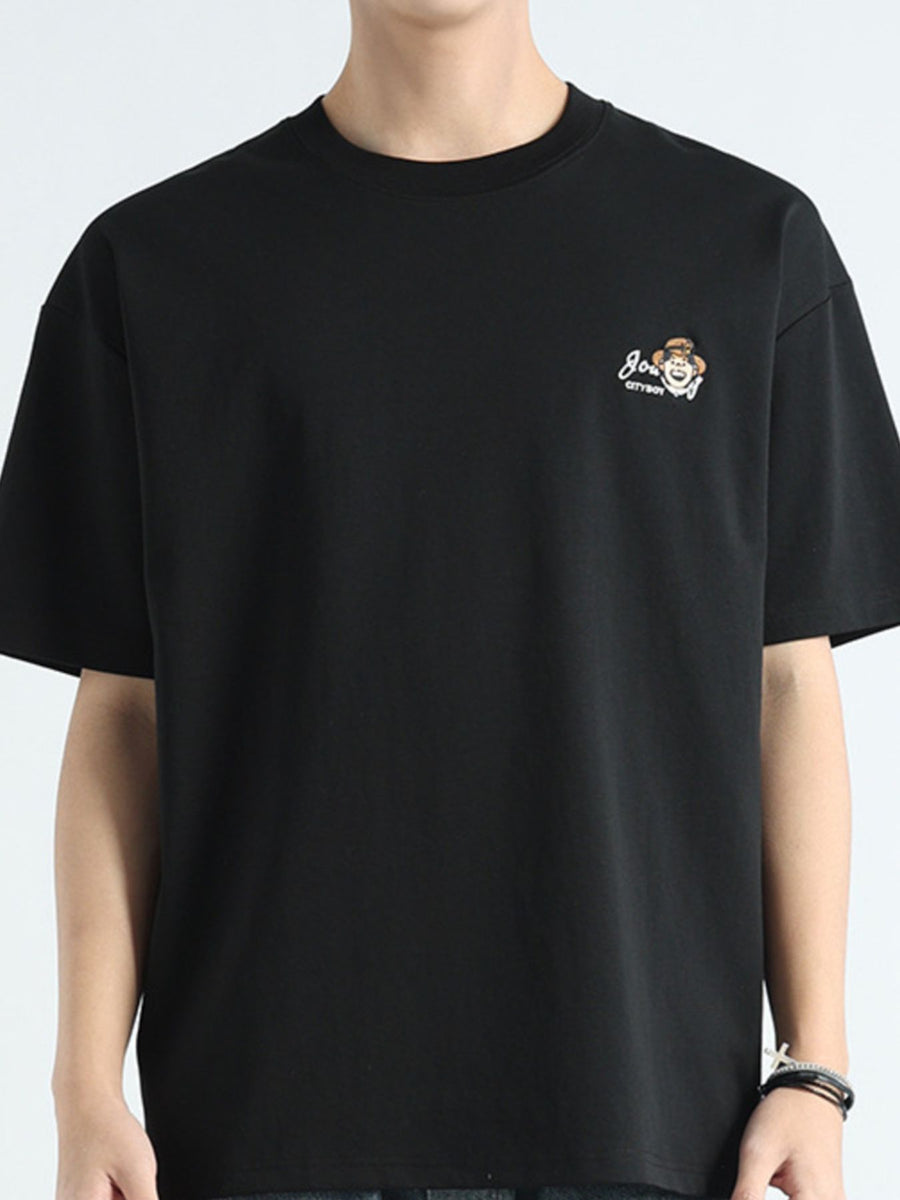 Men's black cotton t-shirt with round neck and embroidered graphic detail on chest.