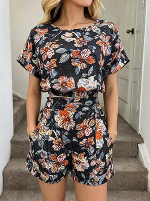 Floral two-piece set in navy blue with crop top and shorts featuring pockets.