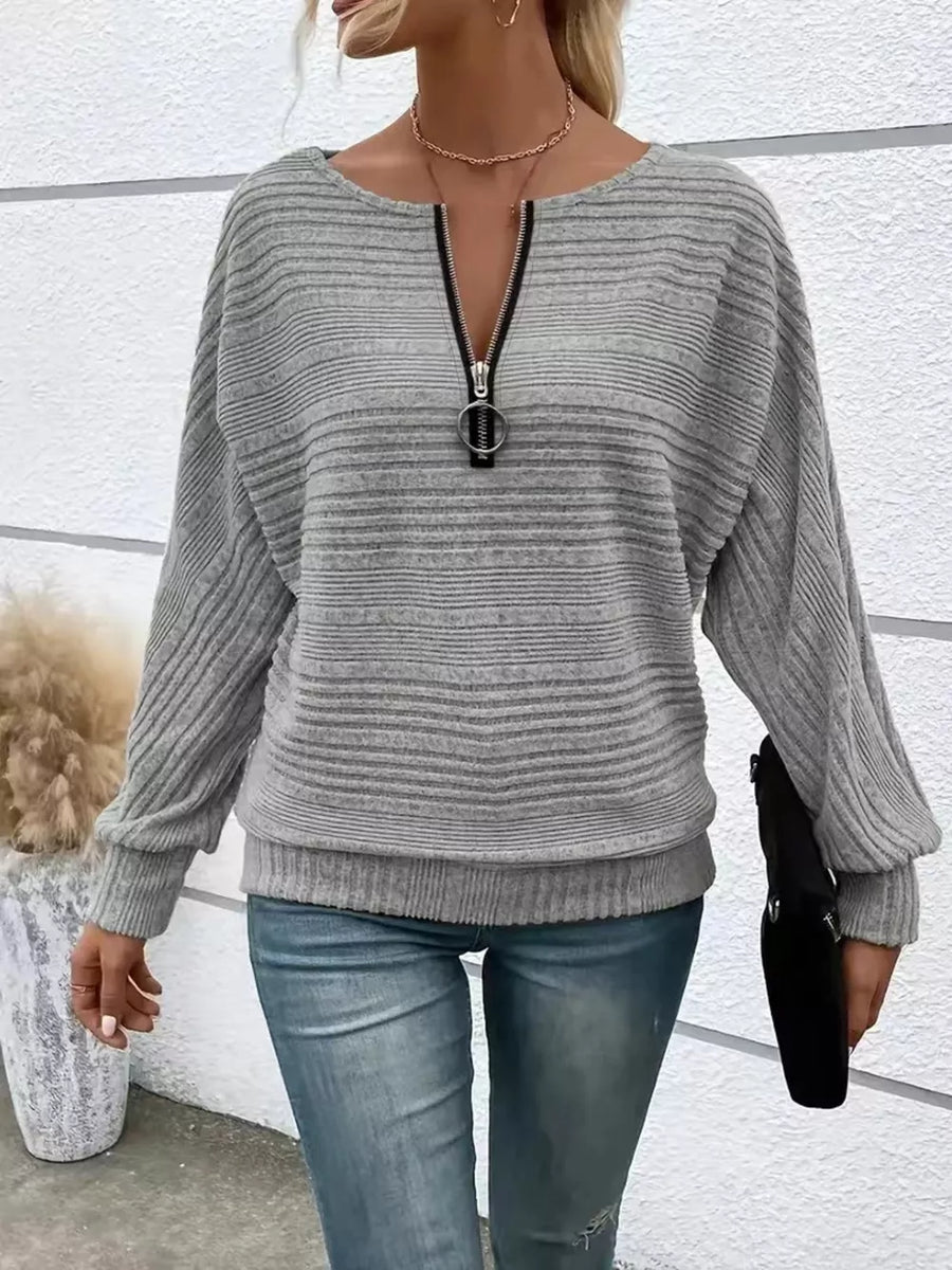 Gray ribbed quarter zip sweatshirt with O-ring pull and dolman sleeves.