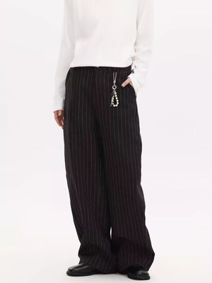 Black pinstripe wide-leg sweatpants with a pearl keychain detail.