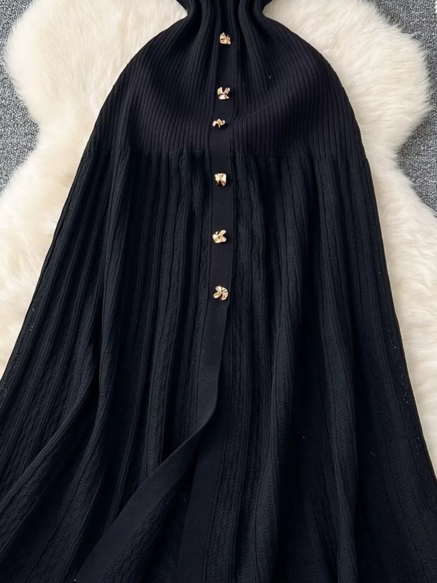 Black knit dress with gold button details and Peter Pan collar detail.