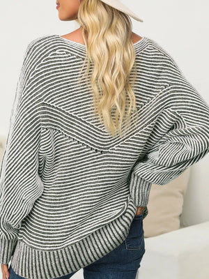 Relaxed ribbed knit sweater with boat neck and stripe pattern in black and white.