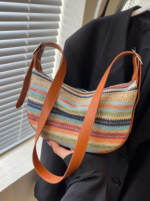 navy blue crossbody bag featuring adjustable strap and striped