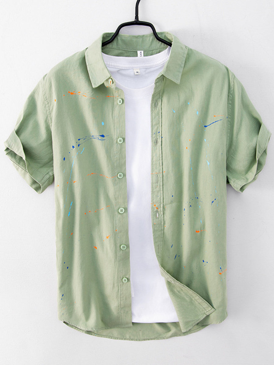 sage green button-up shirt with paint splatter and collared